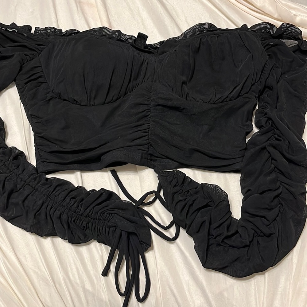 Off the shoulder cropped long sleeve shirt.